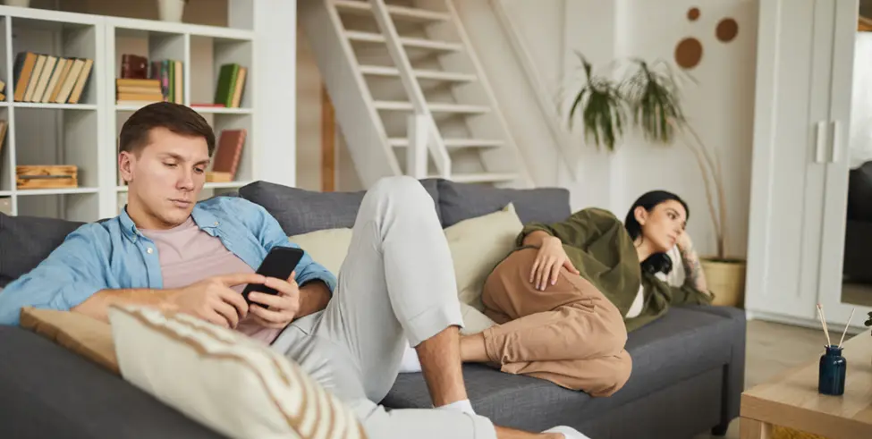 A person sitting quietly and feeling emotionally distant Woman staring out the window, lost in her thoughts Man feeling disconnected during a conversation Person struggling to express their emotions